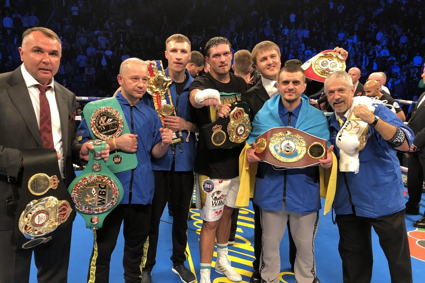 Oleksandr Foka with the corner team and the championship belts after a world title fight